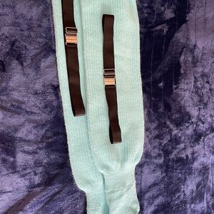 Turquoise leg warmers with black hold up straps. Plus size